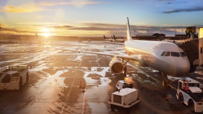 Luggage tractor with electric drive on an airfield with aircraft containers